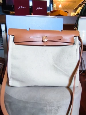 🤍 Minimalist Canvas Tote with Crossbody Strap ✨ - Clean lines, timeless design, and effortless elegance. This beautiful canvas and leather tote is the perfect everyday companion, combining a structured silhouette with a relaxed, understated luxury feel. 🤍  The bag can be turned in side out to change the color to black.  The spacious interior easily fits your daily essentials, making it ideal for work, shopping, travel, or everyday use. ✨🤍  A stylish, practical, and timeless bag 🌟