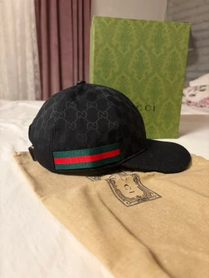 Gucci keps svart UTAN BOX  - Fin gucci keps är i bra skick och kommer me en gucci påse inte som den i bilden en annan och me en tagg