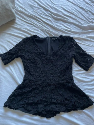 Svart blus från STOCKH LM - Svart spets blus från STOCKH LM i storlek 36/S, v-urringad och kort i ärmarna, aldrig använd och är nyskick