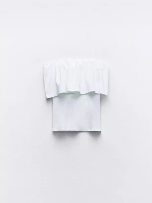 Vit bandeau topp Zara - Trendig vit bandeau topp från Zara med volangdetalj upptill. Axelbandslös design som ger en clean och modern look. Perfekt att styla med höga jeans eller kjol för en fräsch outfit.