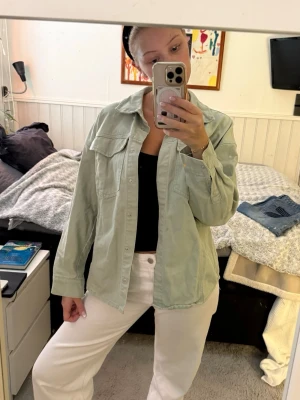 Ljusgrön jeansjacka - Säljer en ljusgrön jeansjacka från Vero Moda. Jackan har klassisk krage, bröstfickor och knappar framtill. Perfekt att slänga över en t-shirt eller hoodie. Passformen är normal och materialet är jeans.