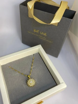 Guldigt halsband med solhänge - Snyggt halsband i guldfärg med ett solformat hänge dekorerat med gnistrande stenar. Kedjan har ett elegant tvinnat mönster som ger extra glans. Funktion: roterar i 360 Material: koppar, rostfritt stål Längd: 50cm Vikt: 0.02kg Skicka ⭐ i meddelande för en hemlig rabatt.