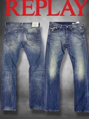 Blå raka jeans från Replay - Säljer ett par klassiska blå jeans från Replay med raka ben och snygg slitning på framsidan. Jeansen har fem fickor, normal midja och detaljerade sömmar. Perfekta för en avslappnad och trendig look.