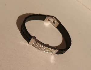 Y2k vintage bracelet - Perfect for the resurgence of y2k fashion this braclet will dazzle on your wrist. It is about 19cm in length. Has 2 small scuffs on the leather and 1 small scuff on the metal. Barely noticeable though! See last 2 pictures.   Bundle discounts: two items 5% off (automatic) three items 10% off, five items 20% off. Message me before purchasing 3+ items for discount.