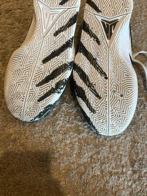 Nike svartvita sneakers - Snygga sneakers från Nike i svart och vitt med klassisk swoosh-logga på sidan. Skorna har en låg silhuett, vit sula med svart mönster och ovandel i mesh och syntetmaterial. Perfekta för dig som gillar sportig och stilren look.