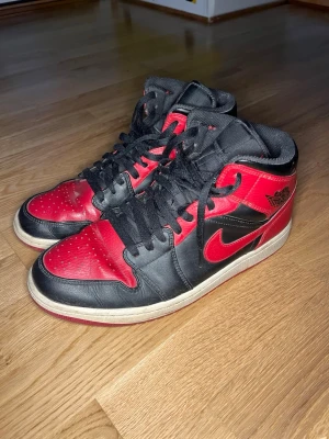 Air Jordan 1 Mid ”Banned” - Säljer ett par använda Jordan 1 Mid ”Banned” inköpta från stockx 2021 (två sista bilderna är från dagen dem levererades). Exkluderat lådan. *Se skick på bilderna*