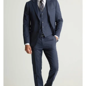 Mörkblå kostym med kavaj och byxor - Snygg blå wool strech kostym från dressman storlek 46 klassisk kavaj med matchande byxor och väst. Använd endast 2-3 gånger slips följer ej med 