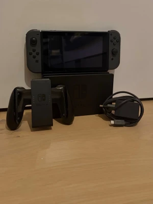 Nintendo switch - Säljer en Nintendo Switch i bra skick.  Ingår: - Konsol (Nintendo Switch) - Docka för TV - Joy-Con handkontroller (grå) - Joy-Con grip - Laddare  Allt fungerar som det ska. Perfekt för både TV-spel och bärbart spelande.   Ingen originalkartong. Normalt slitage kan förekomma.                                                                           Finns för upphämtning / kan skickas.