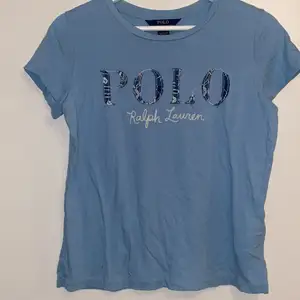 T-shirt från Polo Ralph Lauren säljes. Den är i ”barn” storleken XL (16 år). Skulle tippa på att den anses vara en XS i damstorlek. Tyget är mjukt och den sitter inte slimmat på utan det är en rak lite kortare t-shirt. Säljes då den tyvärr är förliten för mig. 