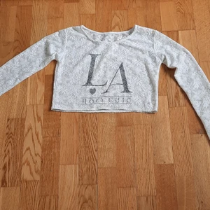White long sleeve see through cropped top - Säljer en av mina favoriter, typ see through cropped top. Det säger "LA 🖤 HOLY CHIC" på den med blommig bakgrund. Kondition: jättebra och knappt använts. Storlek: XS. Bud start från 100 kr + frakt. Ignorera hashtagen.