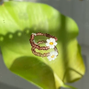 Egentillverkade ring  - Brun ring med blomma, egentillverkad! 🤎                   Passar S                                                                         Säljer för 15kr + 12kr i frakt. Fraktpriset är det samma oavsett antalet ringar man köper ✨