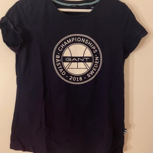 Gant /båstad T-shirt - Gant t-shirt, endast använd 1-2 ggr. Lite skrynklig pga att den legat vikt i en låda. Nypris ca 400kr  (Äkta)  (T-shirten är mörk/marinblå)