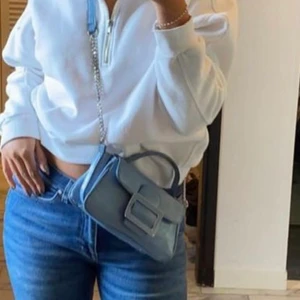 Zara väska  - En liten zara väska i ny skick har använda få gånger och inget smuts eller skador inne i väskan, köp för 260, ljus blå med djurmönster med silvriga detaljer 