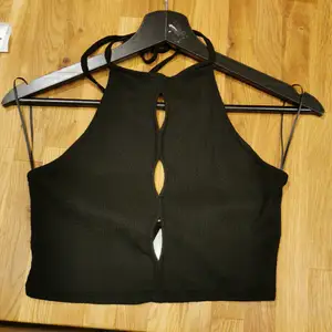 Halter croptop with keyhole cutouts and open back. 