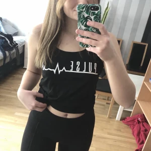 Tränings linne, storlek XS (passar även S) - Skönt träningslinne med texten ”pulse”