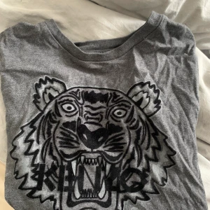 Kenzo tröja  - Långärmad tunn tröja från kenzo, säljes då den inte används! Har två minimala hål på magen som knappt syns, barnstorlek men passar xs.