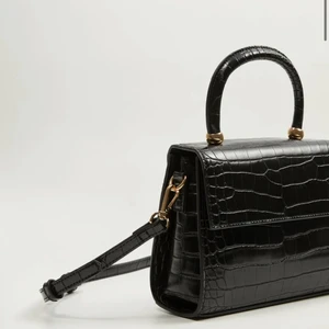 Axelbandsväska  - Säljer en axelbandsväska, däremot kan man ta bort bandet och använda handtaget istället. Måtten är 18x24x7       (Längd xHöjdxBredd. Använd en gång så i mycket bra skick! Frakt tillkommer 