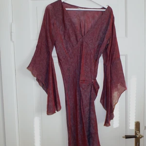 Witchy klänning❤️‍🔥 - Såå speciell klänning i äkta siden, witchy vibes🔮 Har pinnat upp den på ena sidan med en säkerhetsnål pga cute men e ba att ta bort så faller den helt rakt. Har några små hål/finns tecken på användning men inget som jag tycker påverkar helheten