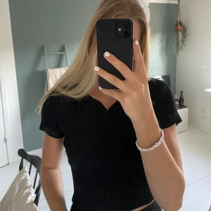 Svart t-shirt från shein med krage - Svart ribbad tshirt med krage och v-rigning. Super stretchig och passar defensivt en större S och möjligtvis M. Inte  farligt genomskinlig och bra kvalitet då jag har tvättat den en gång innan provning. Där efter aldrig använd. Jag är 174 cm och vanligtvis en XS-S in tröjor. Vid köp av den vita likadana toppen kostar båda 100kr ist för 60kr styck. Frakten ej inräknad, spårbar men är öppen för förslag kring priserna😘😁