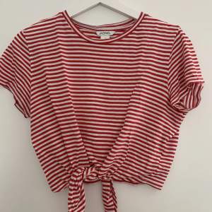 Röd- och vitrandig t-shirt med knytning nertill. I storlek S