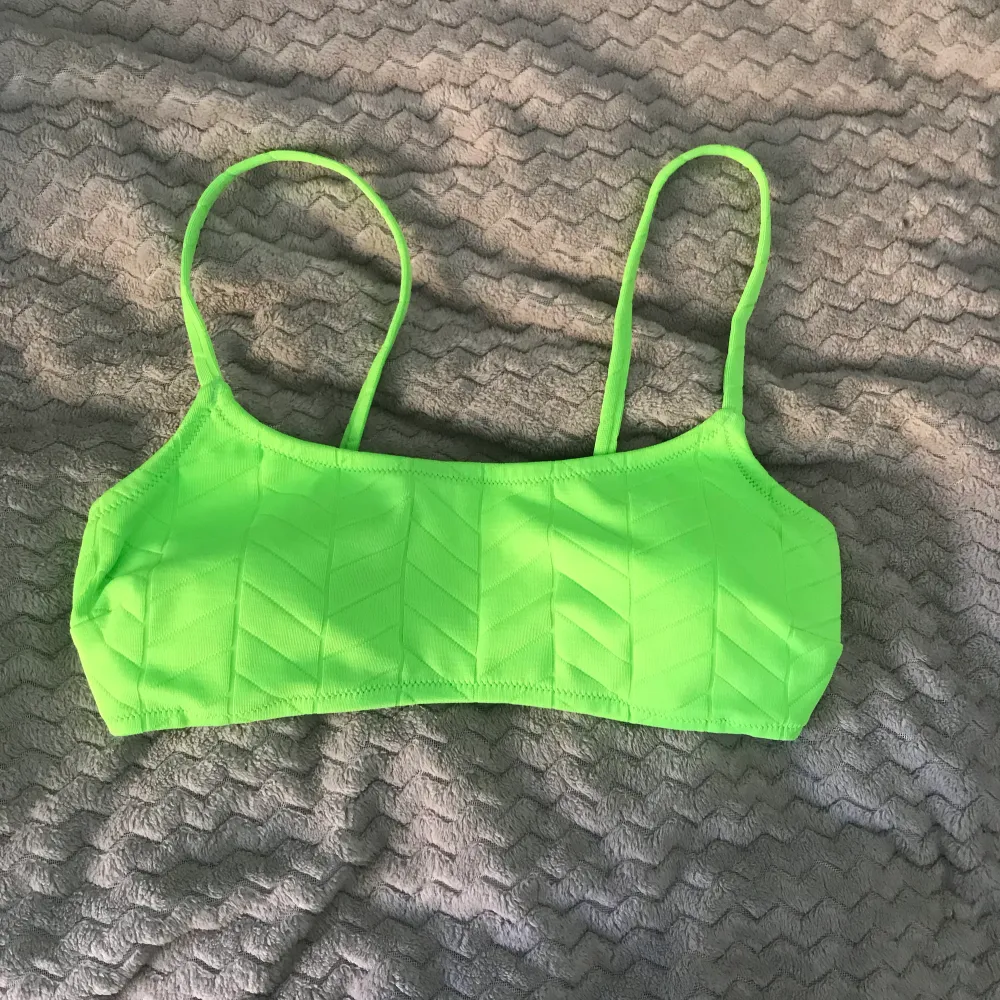 En limegrön bikinitopp som inte kommer till användning längre! Super fin skicka fortfarande! Har knäppe baktill, justerbara axelband och urtagbara pads!😻 . Övrigt.