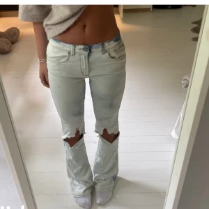 Lågmidjade bootcut jeans  - Lågmidjade bootcutjeans! Från bikbok, blekt o klippt hålen själv! Är 164cm lång bär 34/36