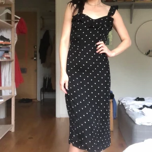 Prickig satin klännibg - Silkig prickick klänning i svart och vitt. Köpt second hand men från hm trend. Volanger på axelbanden och vid urringningen. Liten urringning och knyt i ryggen. Lite så fransk och romantisk! Tycker mycket om men säljes pga lite för liten för mig som 36a!