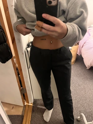 Lågmidjade kostymbyxor  - Ett par lågmidjade kostymbyxor i färgen mörkgrå. Står ingen storlek men passa mig som bruka ha 34-36. Aldrig använda 