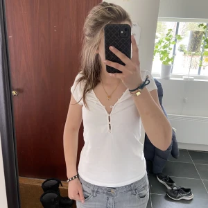 Så fin💕 - Säljer denna vita tshirten med knappar som man kan välja hur mycket den ska vara v-ringat 💕 Säljes billigt då jag inte amvänder den och vill bli av med det! 