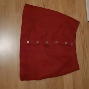 Kort röd kjol med knappar 