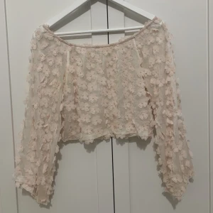 Topp från Ida Sjöstedt  - Topp/blus från Ida Sjöstedt med blommor.🌸 så himla fin men kommer tyvärr inte till användning. Har en liten fläck men den syns knappt, kan skicka bild vid förfrågan. 