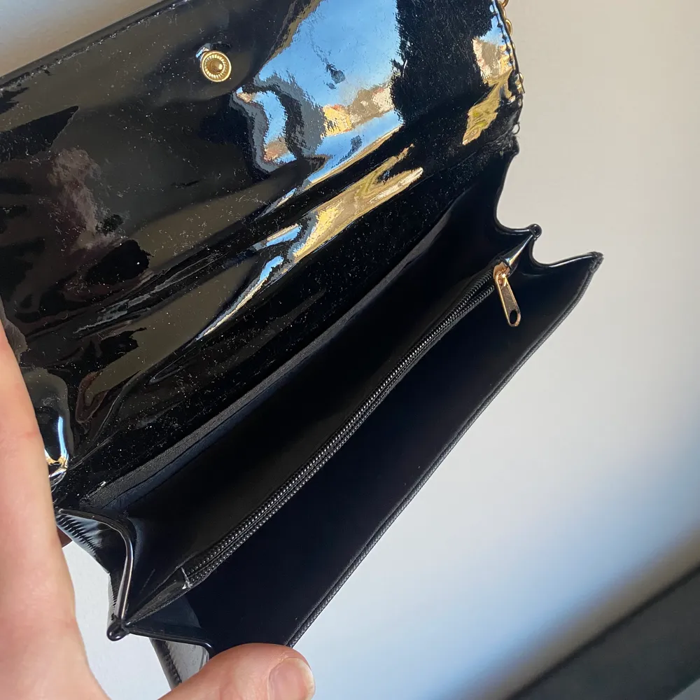 Snygg liten svart crossbody väska med dragkedja på insidan. Guldiga detaljer. . Väskor.