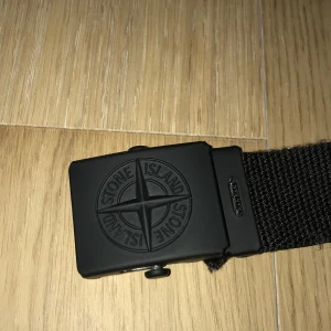 Stone island bälte  - Äkta stone island bälte. Stolek 3 (80cm) junior.Låda medföljer.Nypris ca 700kr. 