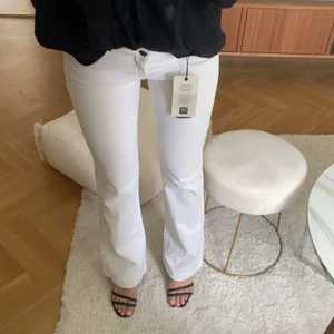 Oanvända låga vita jeans - Jag är 165cm lång. Med bootcut. Lapparna kvar, helt oanvända. Stretchiga och mjukt material! Säljer även klackarna