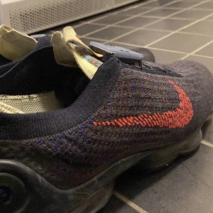 Nike skor - Nike Vapormax Flyknit Obsidian. Köpte skorna för ungefär 2 månader sen och de har ej kommit till användning just därför jag säljer dem. Box ingår. Passar även bra för kvinnor. 
