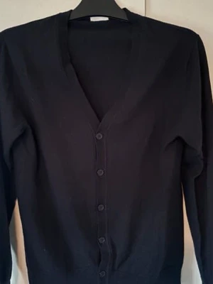 John Henric cardigan - Sprillans ny oanvänd svart John Henric Kofta i storlek L men sitter 100% som M säljes. Den är av högsta kvalite finstickad av 100% merinoull. Sjukt snygg och skicket är som sagt 10/10! Färgen är typ svart/väldigt mörk blå. Tveka inte vid minsta fråga eller fundering😃