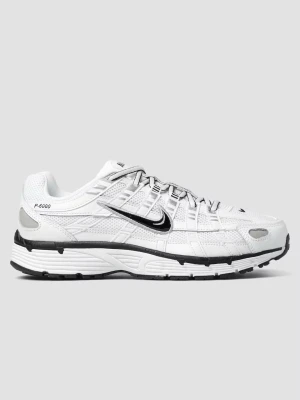 Nike P-6000 vita storlek 44 - Nike P-6000 sneakers i vitt med svarta detaljer och meshpaneler för extra ventilation. Skorna har en sportig retrodesign, snörning framtill och en tjock, bekväm sula. Swoosh-logga på sidan och små loggor på tungan och hälen. Perfekta för dig som gillar streetwear.