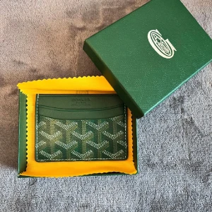 Korthållare -   *   Elegant design *   Tillverkad av kvalitetsmaterial *   Livfull blå färg *   Distinkt, mönstrat tryck *   Flera fack för kort och sedlar *   Praktisk och stilfull *   Logotyp för märke *   Kombination av funktionalitet och sofistikation