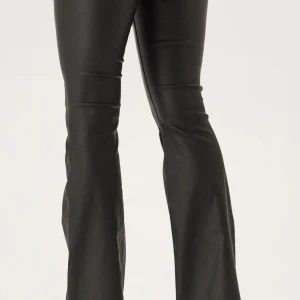 Svarta bootcut byxor i skinnimitation - Snygga svarta byxor med bootcut passform i skinnimitation. De har klassisk femficksdesign, knapp och dragkedja framtill samt en smickrande siluett med utsvängda ben. Perfekta för dig som vill ha en edgy och trendig look. Medelhög midja  (Bilderna är från bubbelrooms Skinnbyxor, men veramodas ser likadana ut, kan skicka fler bilder med dom på) 