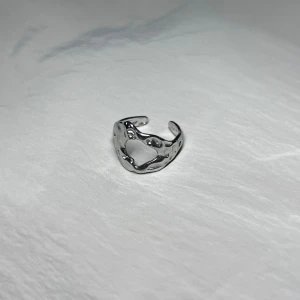 Æther Silver Hollow - An asymmetrical sculpture in motion — void meets form in stainless steel. Adjustable & rust-free