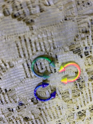 Färgglada ringar till piercing - Säljer ett gäng coola ringar till piercing i olika färger som blå, rosa, grön, lila och regnbågsfärgad. Alla har spetsiga ändar och vissa har mönster som gör dem extra unika. Perfekt för dig som vill mixa och matcha din stil.  45kr/3st/bild 