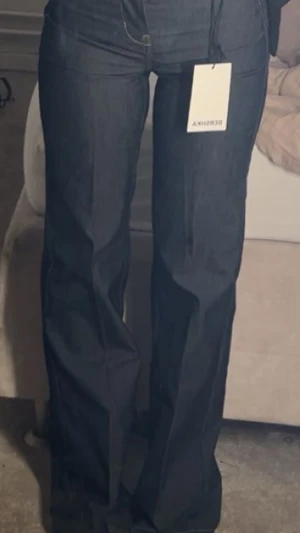 Mörkblåa Bershka jeans  - Snygga mörkblå jeans från Bershka med wide passform. Perfekta för dig som gillar trendiga och bekväma byxor. Str 34 säljs för 300kr!