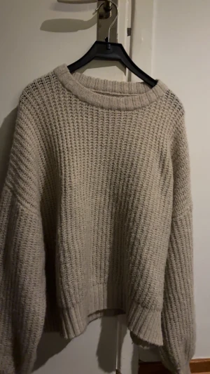 Beige stickad tröja från Even&Odd - Säljer en beige stickad tröja från Even&Odd med grov ribbad struktur och rund hals. Tröjan har långa ärmar och breda muddar vid ärmslut och nederkant. Perfekt för dig som gillar en chill och oversized look. Använt tröjan ett fåtal gånger men legat i garderoben ett tag💞 pytte lite nopprig men inget som syns! 