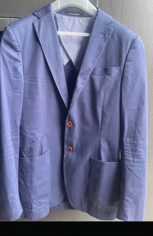 Kavaj Oscar Jacobsson 48 - Klassisk kavaj i en tidlös design från Oscar Jacobsson  Str 48  Färg blå