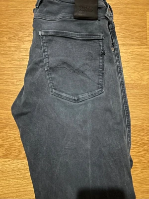 Replay hyperflex - Mörkblå Replay Hyperflex-jeans i klassisk passform. Tillverkade i det populära Hyperflex-materialet som ger mycket stretch och hög komfort. Jeans med fem fickor och Replay-logga. Bra skick. Men ett litet hål på höra ben ser knappt. 
