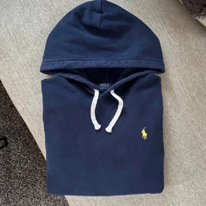 Marinblå Ralph Lauren Hoodie  - Snygg hoodie från Ralph Lauren. Storlek S, passar mer som en XS. Fint skick. Längd från axel o ner 60 cm, bredd under armhålorna: 50 cm. Hör gärna av er vid funderingar🙌🏻