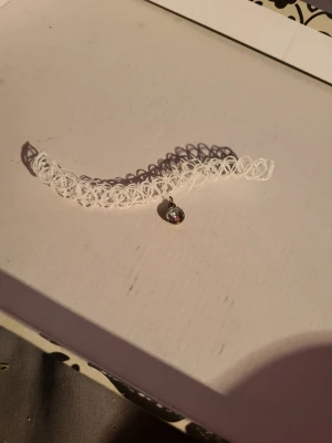 Choker necklace  - White tattoo choker necklace with fake gemstone inlaid in metal. Diameter aproximently 15cm with lots of stretch.  Bundle discounts: two items 10% off (automatic) three items 15% off, five items 20% off. Message me before purchasing 3+ items for discount.