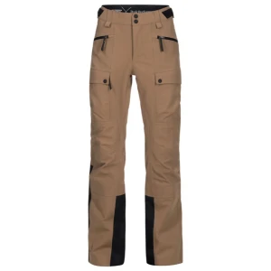 Peak Performance KIRKWOOD skidbyxor beige/svart - Peak Performance täckbyxor i beige med svarta förstärkningar nedtill. Byxorna har stora fickor med knappar, dragkedjor framtill och detaljer med svart text längs benet. Perfekta för vinter och höst. Oanvänd utan lappar. 