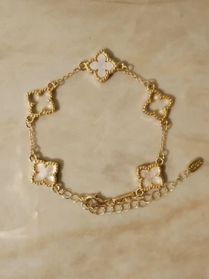 Guldfärgat armband med vita klöver✨️🤍 - Guldfärgat armband med vita klöver✨️🫶