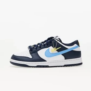 Nike Dunk Low blå/vit sneakers - Nike Dunk Low sneakers i vitt och marinblått skinn med ljusblå swoosh och gula detaljer på hälen. Klassisk låg modell med snörning och platt sula. Perfekta för dig som vill sticka ut med en fräsch färgkombo och sportig vibe.